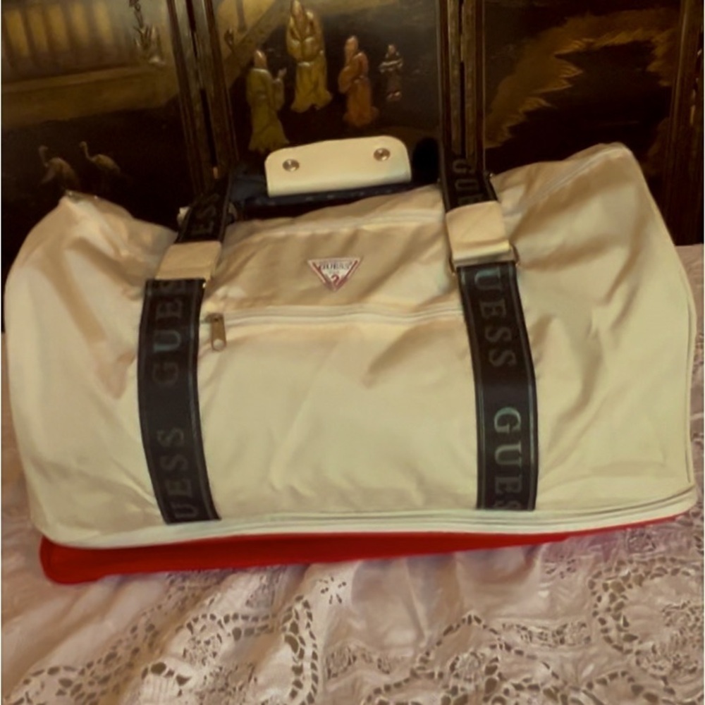 Duffle by Guess white/cream colored tote with extra red storage on the bottom.